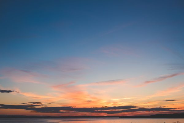 A beautiful sunset with vibrant colors over a tranquil body of water. Nature 4K