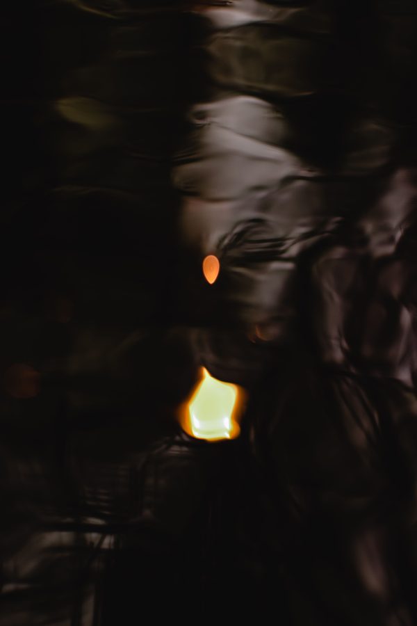 A blurred, abstract image of candlelight creating a mysterious atmosphere in the dark. Mobile 4K