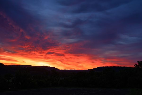 A breathtaking view of a colorful sunset over a rural landscape, showcasing dramatic skies and natural beauty. Nature 4K