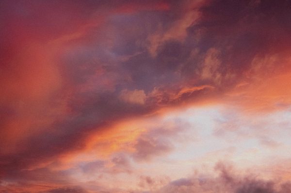 A breathtaking view of a dramatic sunset sky with vivid colors and clouds. Dark 4K