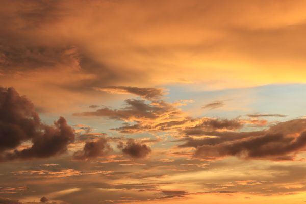 A breathtaking view of dramatic golden clouds during sunset with a serene sky. Dark 4K