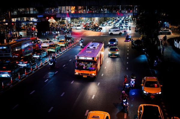 A bustling urban street at night with vibrant traffic and city lights, showcasing lively city nightlife. Voitures 4K