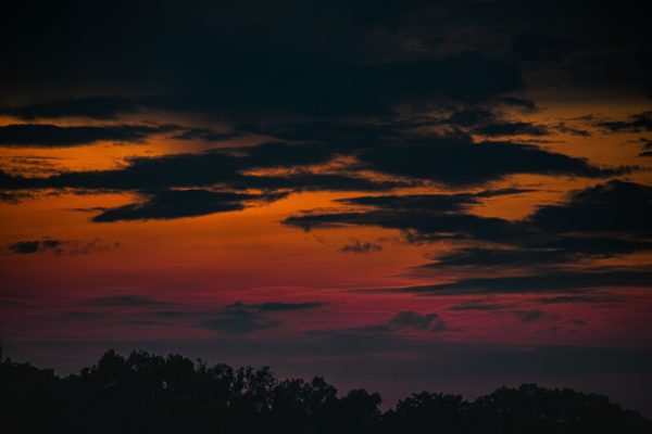 A captivating sunset with dramatic clouds and vibrant colors, offering a stunning view. Nature 4K