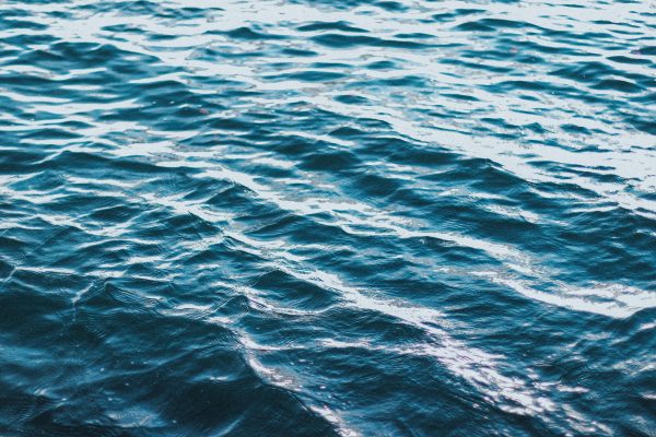A close-up view of sunlit ocean waves, highlighting the beautiful rippling water effect. Nature 4K