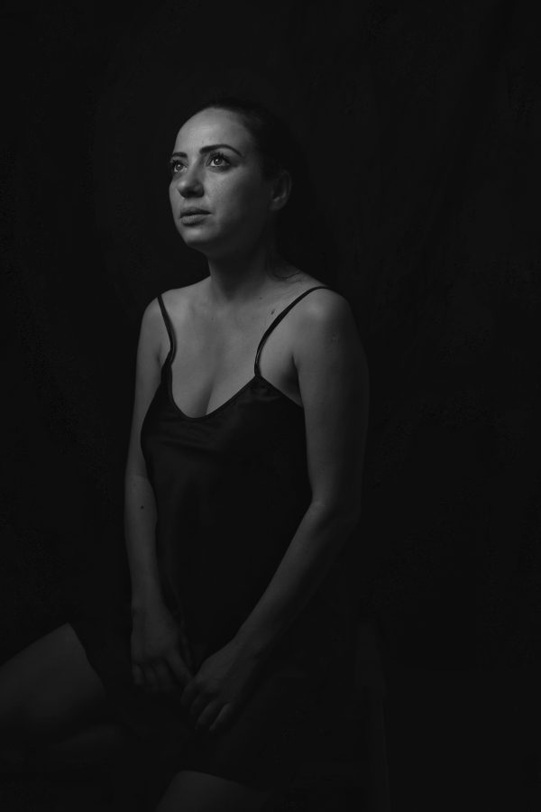 A contemplative woman gazes upward in this moody, black and white portrait. Mobile 4K