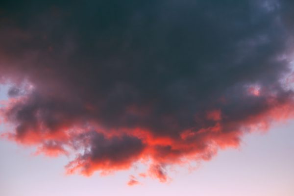 A dramatic sky featuring vibrant red and dark clouds during sunset, showcasing nature's beauty. Dark 4K