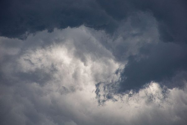 A dramatic view of dark clouds swirling in a moody, overcast sky. Dark 4K