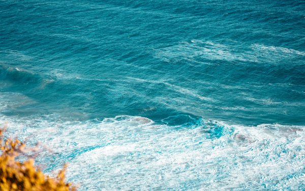 A dynamic view of ocean waves with a bright blue hue, invoking a sense of tranquility. Nature 4K