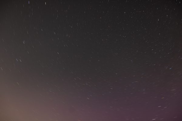 A mesmerizing long exposure photo capturing a starry night sky in Hamburg, showcasing the cosmic beauty of the galaxy. Espace 4K