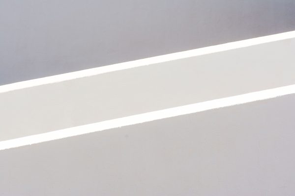 A minimalist abstract photo showcasing light and shadow on a textured surface. Minimaliste 4K