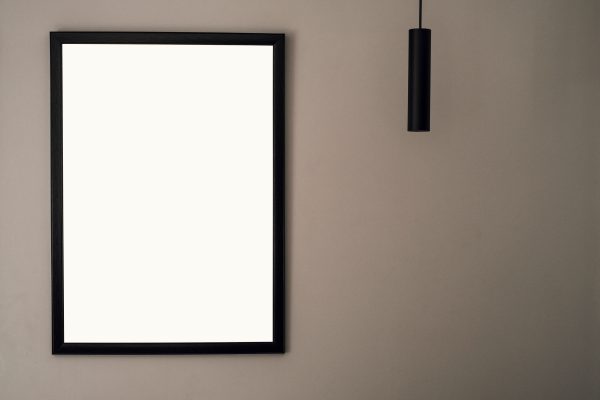 A minimalist picture frame on a neutral wall with hanging light and ample copy space. Minimaliste 4K