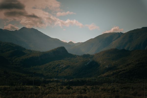 A peaceful view of mountains with lush greenery under a cloudy sky, evoking tranquility. Nature 4K