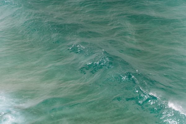 A serene aerial capture of turquoise waves in Byron Bay, New South Wales, Australia. Nature 4K