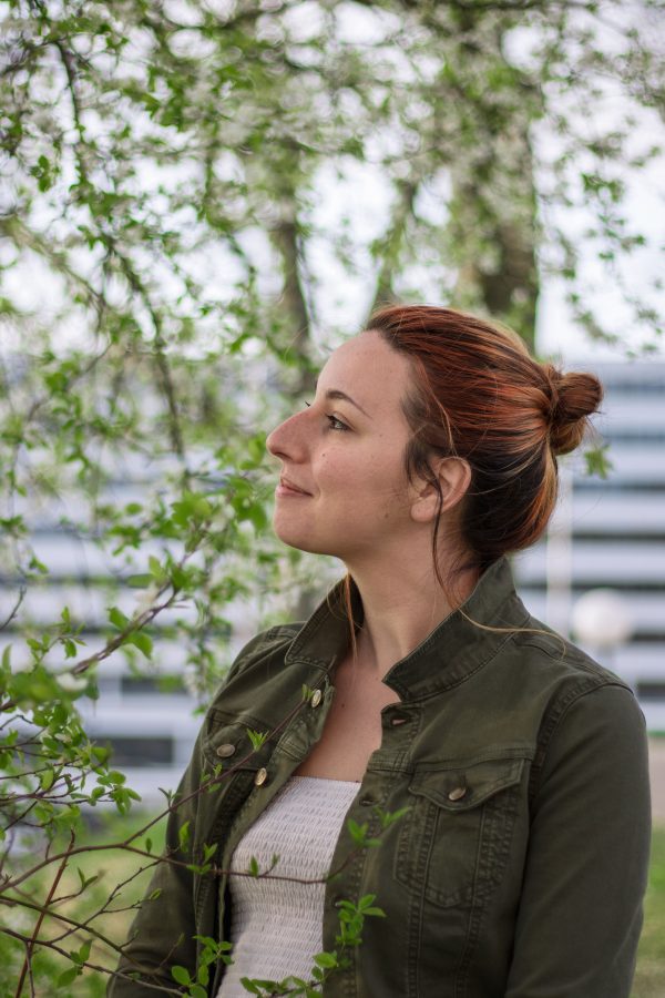 A serene portrait of a redhead woman enjoying nature in spring. Mobile 4K