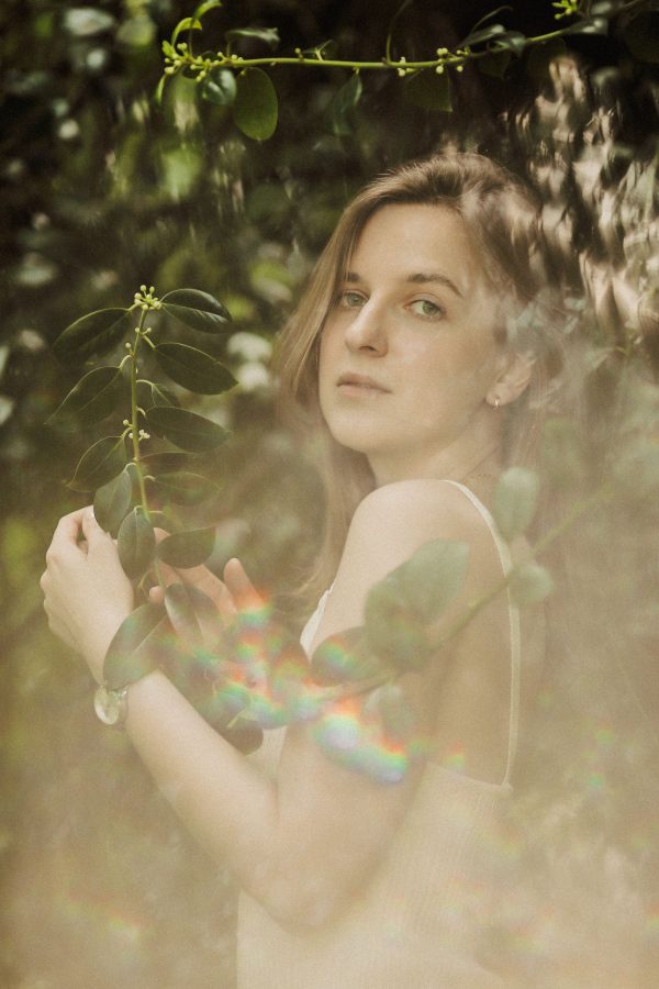A serene portrait of a woman amidst lush greenery, showcasing natural beauty and tranquility. Mobile 4K