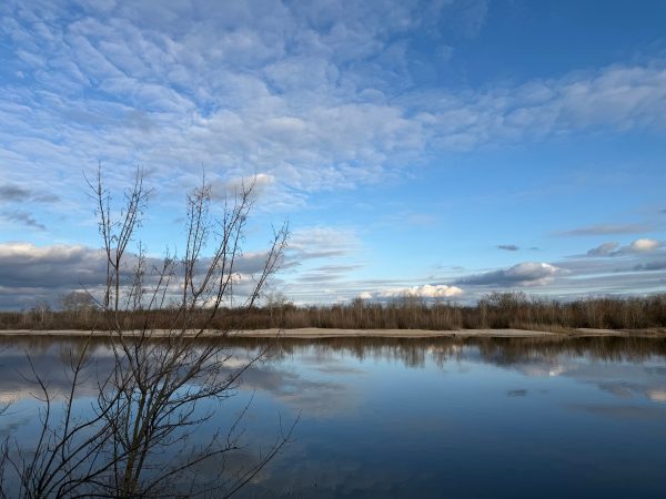 A serene spring scene with reflective waters and a clear blue sky in Kalinin, Russia. Nature 4K