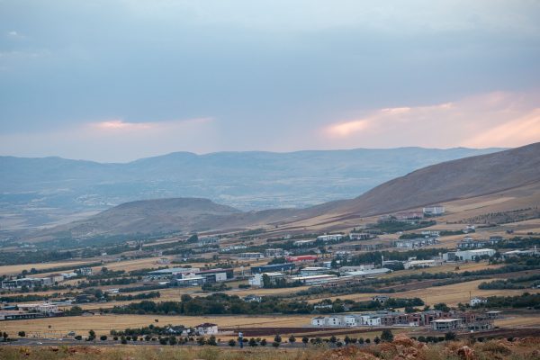 A serene view of Elazig's countryside with hills and fields under a pastel sky at dusk. Nature 4K