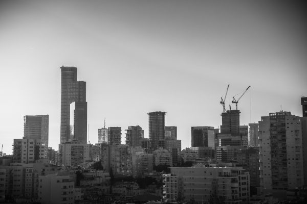 A striking black and white cityscape photo featuring towering skyscrapers and cranes. Architecture 4K