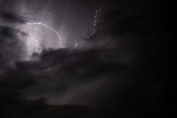 A striking image of a lightning bolt illuminating a stormy night sky, capturing the essence of nature's power. Dark 4K