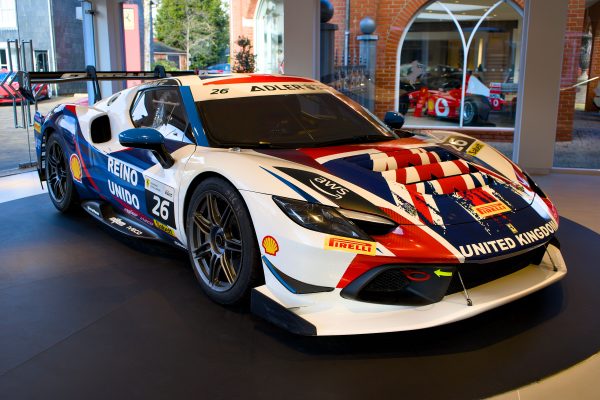 A striking race car featuring a Union Jack design displayed indoors, showcasing speed and power. Voitures 4K