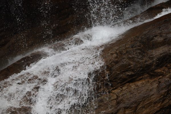 A stunning close-up of a waterfall cascading over rocky terrain, showcasing natural beauty. Nature 4K