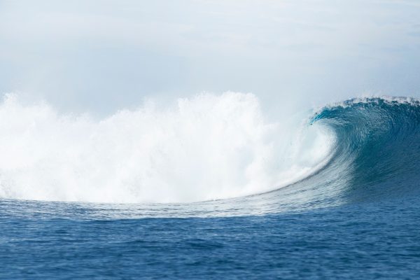 A stunning ocean wave crashing majestically, captured off the coast of Fiji, showcasing nature's beauty. Nature 4K