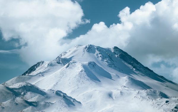 A stunning snow-covered mountain under a blue sky in Aksaray, Turkey. Nature 4K