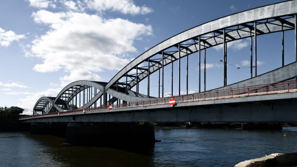 A stunning steel arch bridge in Hamburg under a clear blue sky, symbolizing modern architecture. Architecture 4K
