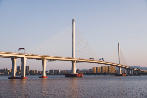 A stunning view of a cable-stayed bridge over water at sunset, capturing urban architecture. Architecture 4K