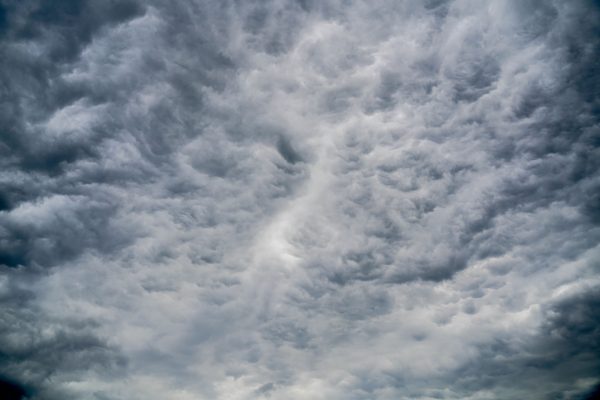 A stunning view of dramatic cumulus clouds filling the sky, showcasing dynamic weather patterns. Dark 4K