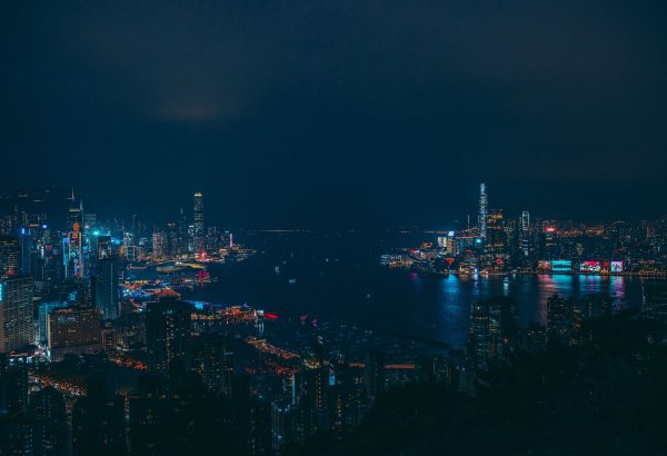 A stunning view of Hong Kong's illuminated skyline with reflections on the harbor at night. Architecture 4K