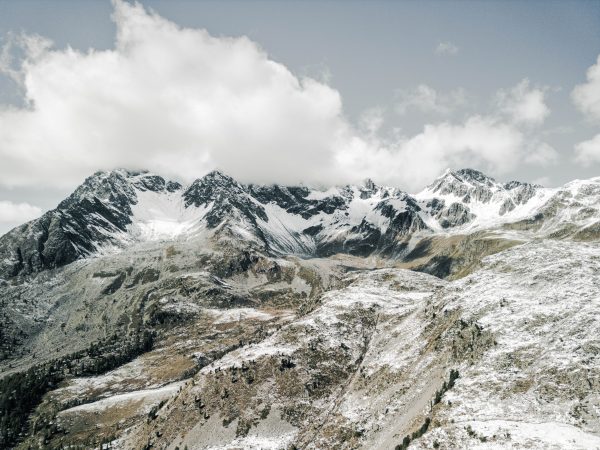 A stunning view of snow-covered mountains in Poschiavo, Switzerland, showcasing natural beauty and serene landscapes. Nature 4K