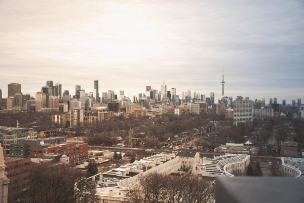 A stunning view of Toronto's skyline featuring the iconic CN Tower under an overcast sky. Architecture 4K