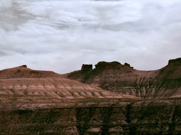 A stunning view of Wyoming's rocky landscape under a dramatic sky, captured during the day. Nature 4K