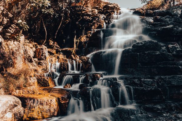 A stunning waterfall flows over layered rocks in Brazil, capturing nature's beauty. Nature 4K