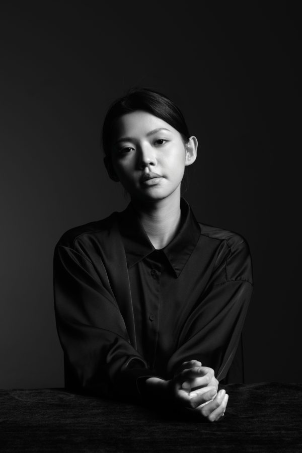 A stylish black and white portrait of a woman in deep contemplation. Mobile 4K