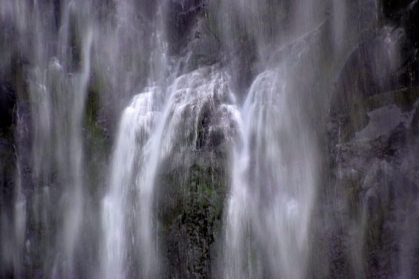 A tranquil long exposure shot of a cascading waterfall, creating a smooth flowing water effect. Nature 4K