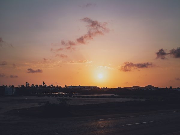 A tranquil sunset with scattered clouds over a quiet coastal landscape. Nature 4K