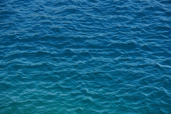 A tranquil view of the azure ocean with gentle ripples creating a serene pattern on the water's surface. Nature 4K