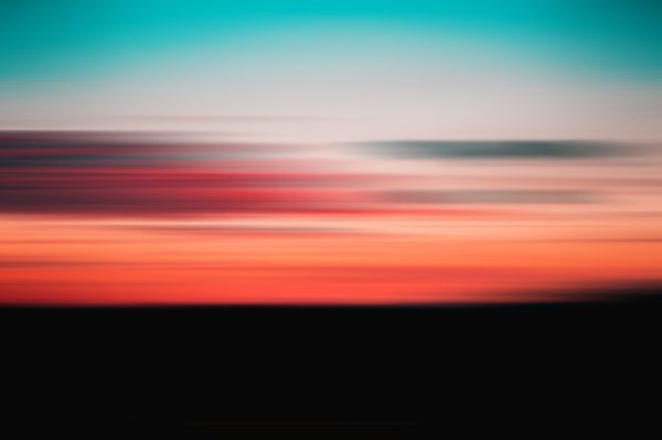 A vibrant and abstract blurred depiction of a sunset with stunning colors. Nature 4K