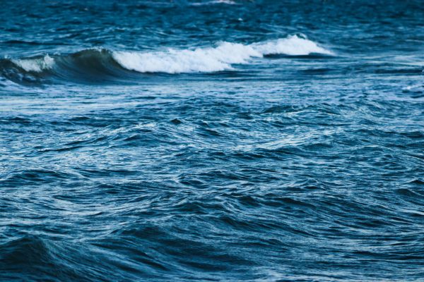 A vivid scene of ocean waves crashing and creating dynamic water textures. Nature 4K