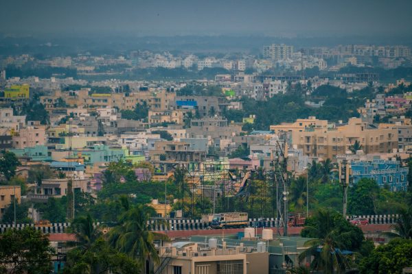 Aerial view of Bhubaneswar's colorful buildings and lush greenery, showcasing urban life in India. Architecture 4K