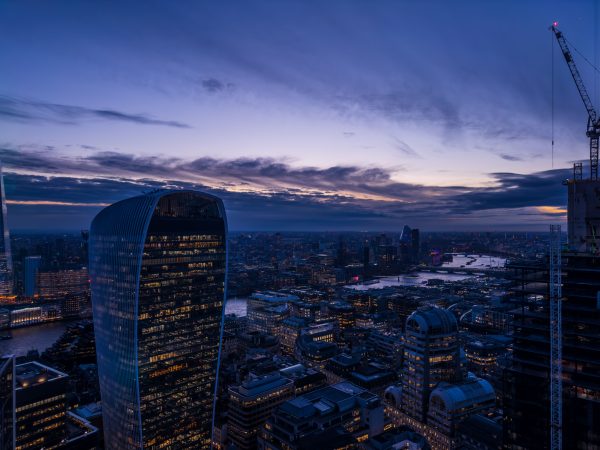 Aerial view of London's skyline at twilight featuring the iconic 20 Fenchurch Street building. Architecture 4K