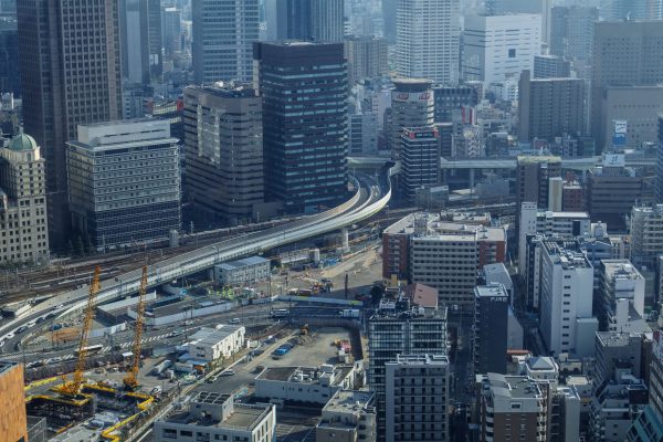 Aerial view of Osaka's urban landscape featuring a modern skyline and elevated highways. Architecture 4K
