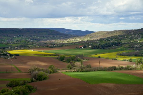 Aerial view of rolling hills and green fields in Nagygörbő, Hungary, showcasing pastoral beauty and tranquility. Nature 4K