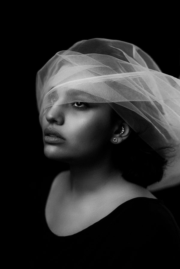 Artistic black and white portrait of a woman with sheer fabric, exuding elegance and mystery. Mobile 4K