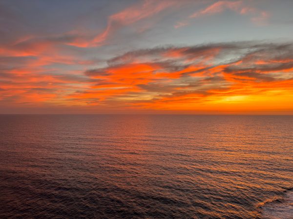 Beautiful ocean horizon at sunset with vivid orange clouds, perfect for tranquil nature scenes. Nature 4K