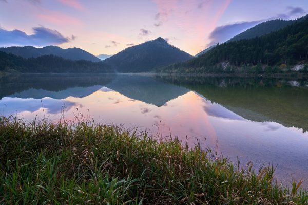 Beautiful sunrise over a tranquil lake in Reit im Winkl, Bavaria, with mountain reflections. Nature 4K