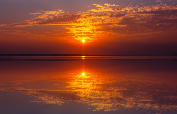 Beautiful sunset over Florida ocean with stunning reflection and golden sky. Nature 4K