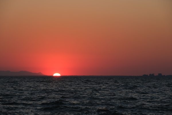 Beautiful sunset over the ocean with a mesmerizing red sky, perfect for serene and peaceful moments. Nature 4K